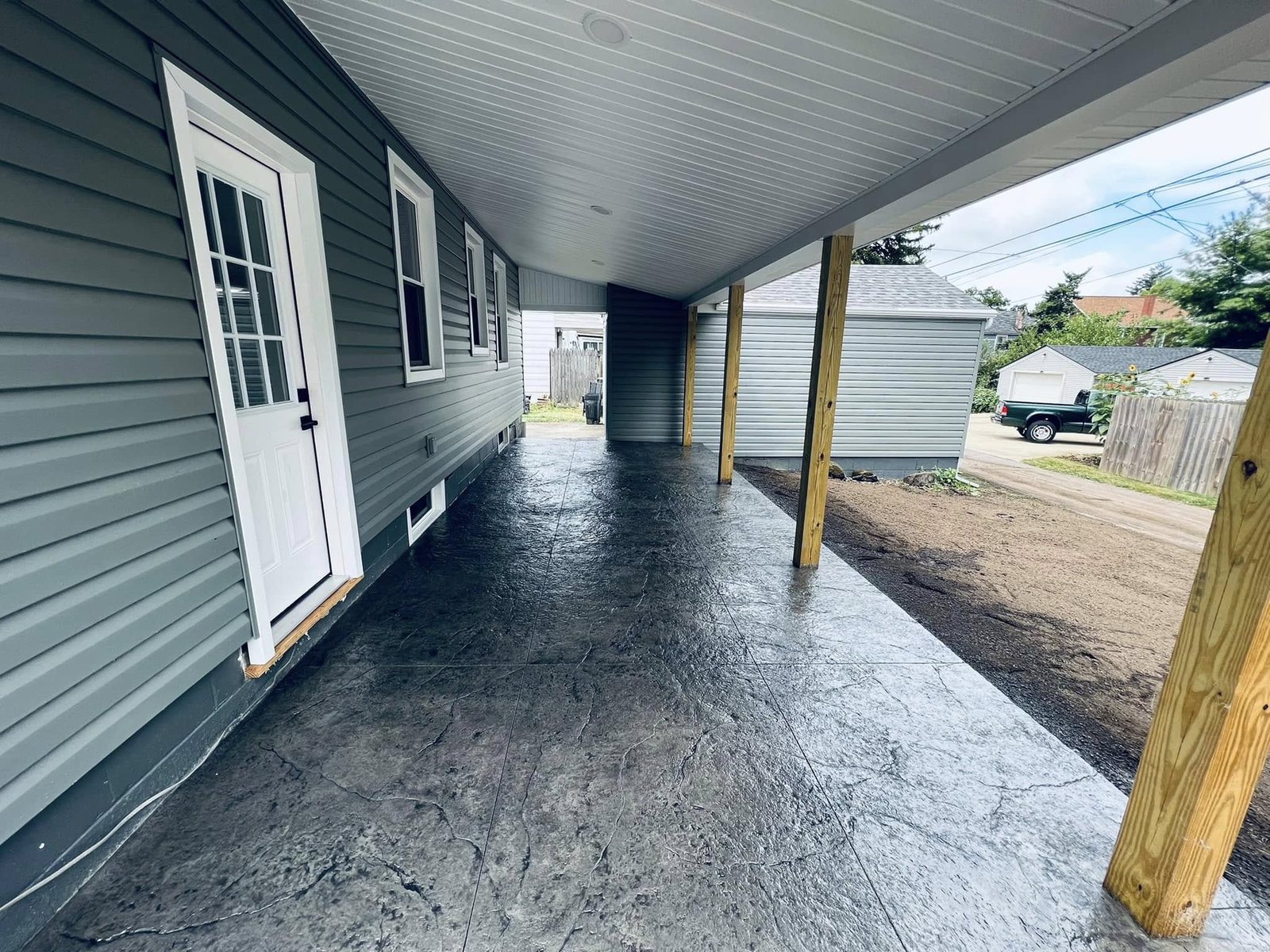 Covered stamped-concrete patio with a compass-star medallion by Custom Crete