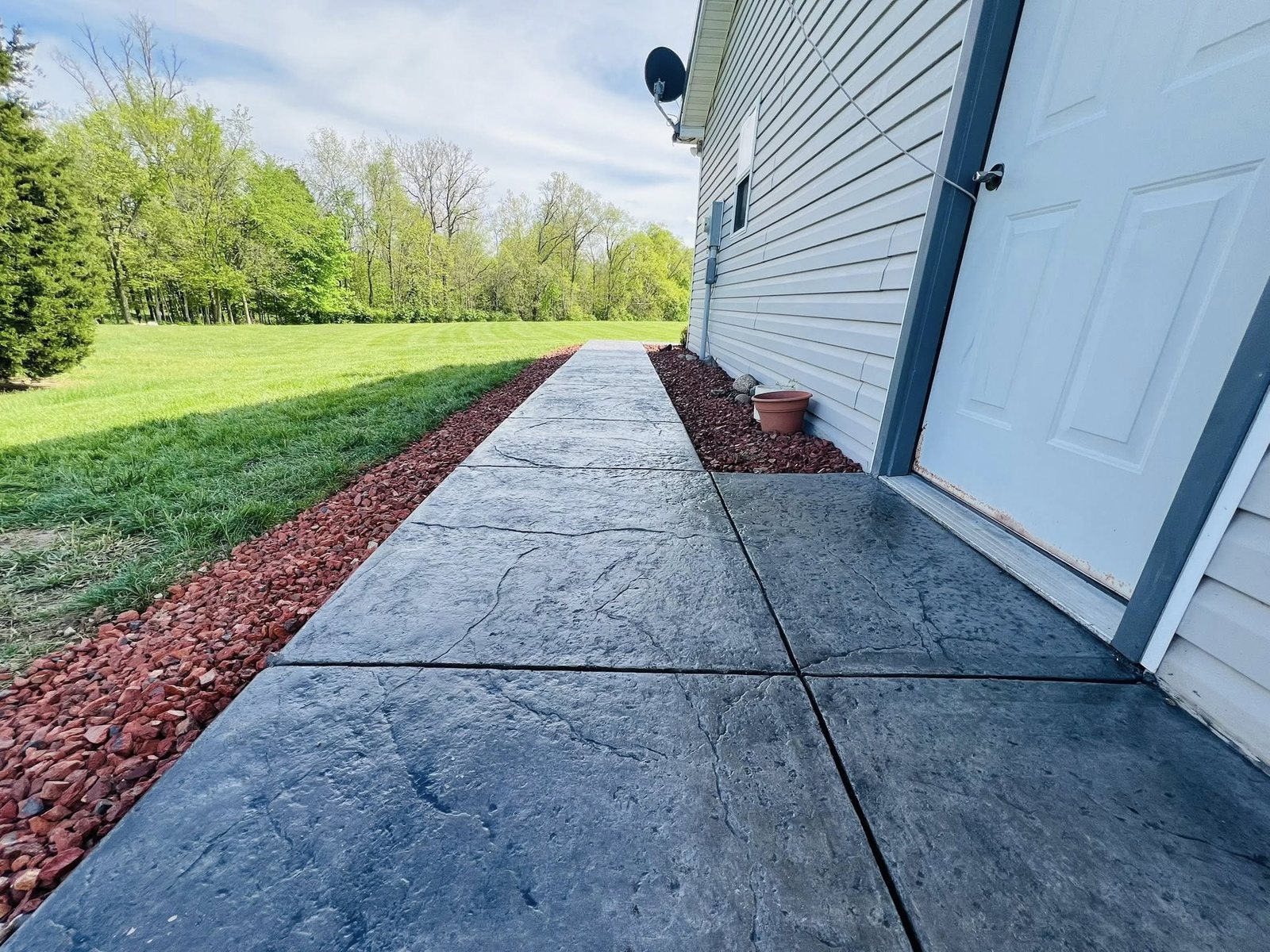 Compass-star medallion at the center of a round stamped concrete patio