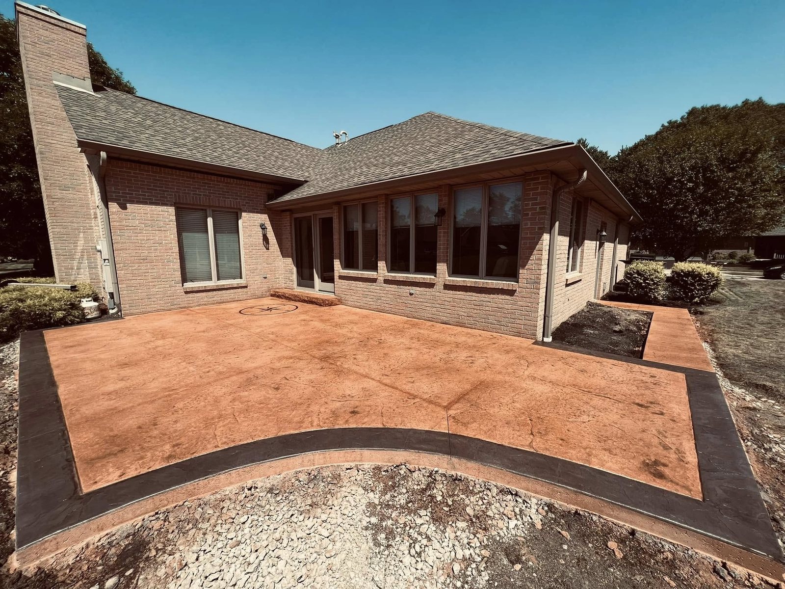 Tan herringbone brick-pattern stamped concrete patio