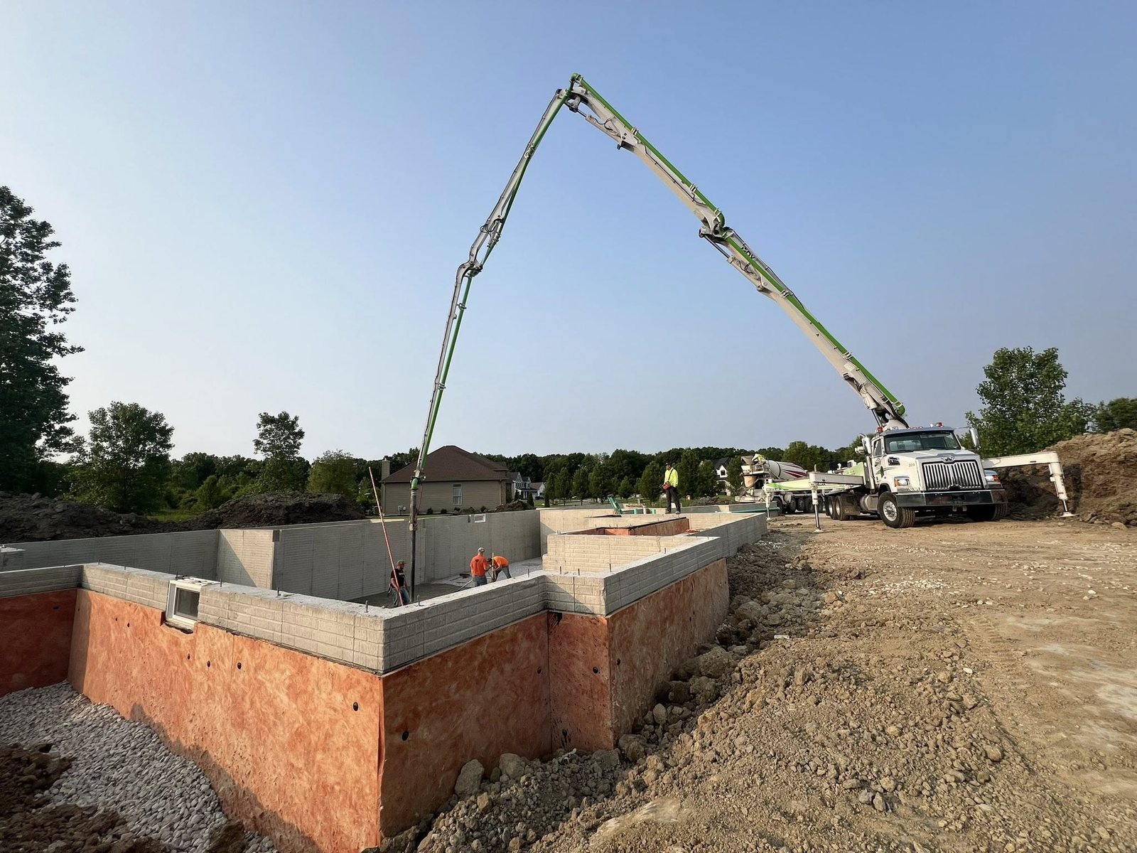 Concrete foundation pour with a pump truck on a commercial site