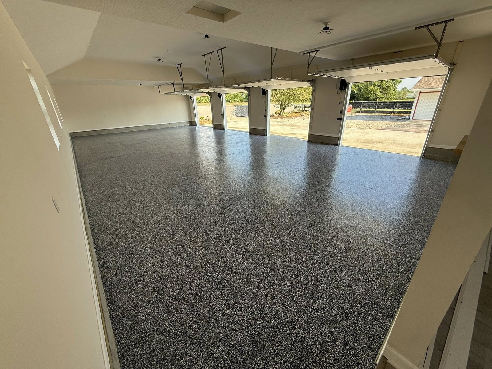 Bright tan flake epoxy coating on a residential garage floor