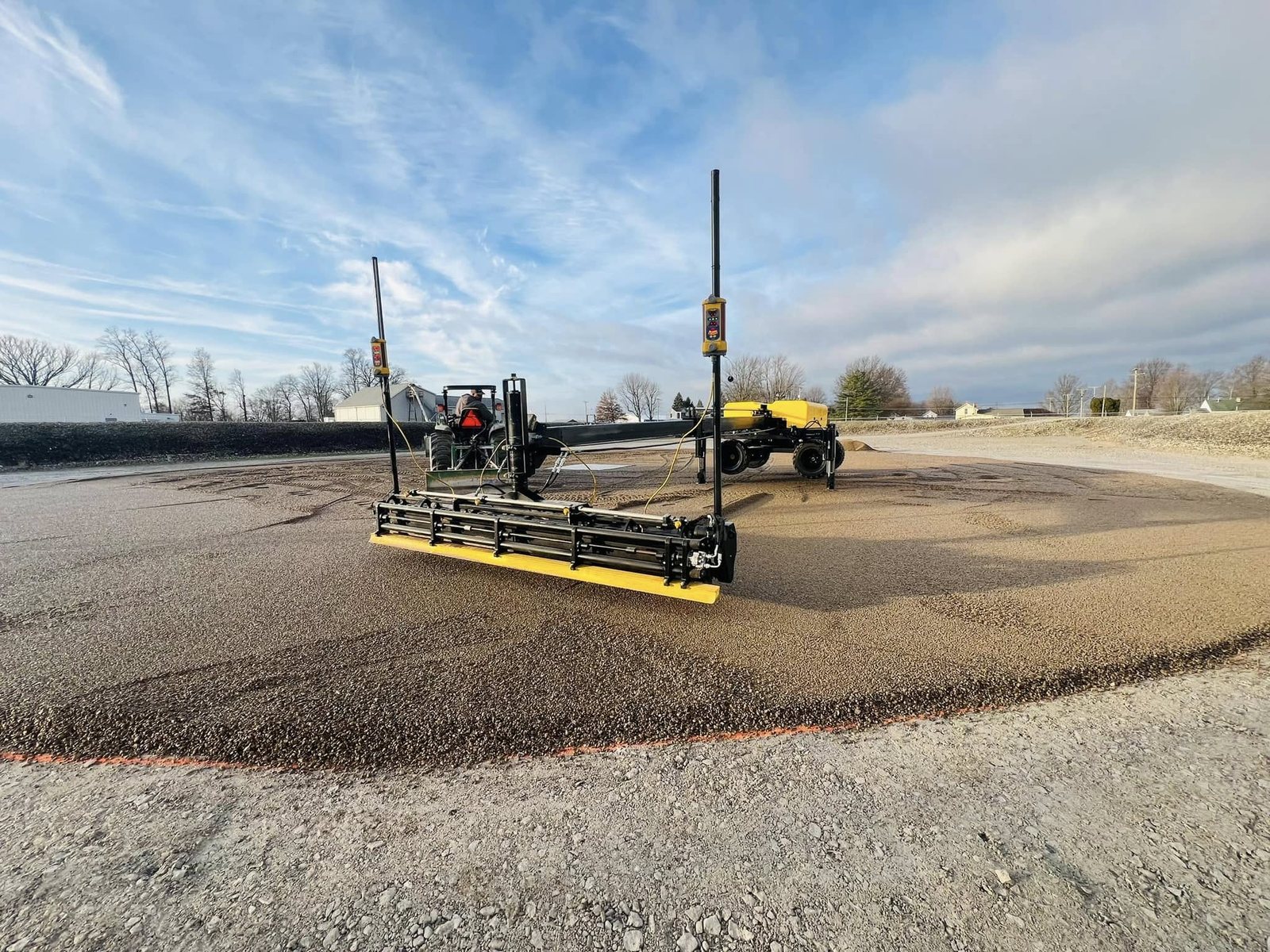 Large commercial concrete pad being finished with a laser screed.